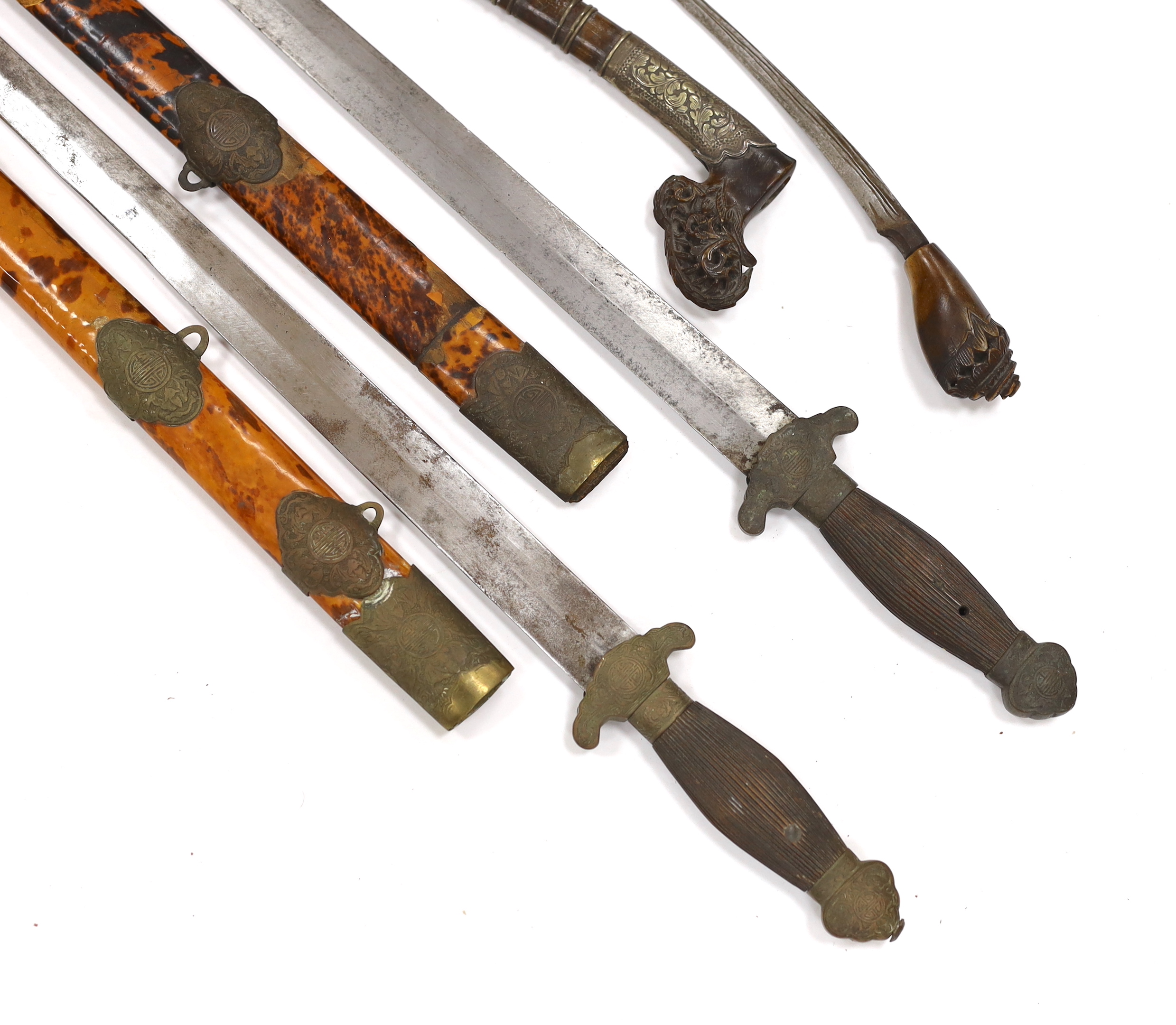 Two Chinese short swords (Jian) in faux tortoiseshell veneered scabbards and a Sumatran knife dagger with sheath (sekin), blade 42cm